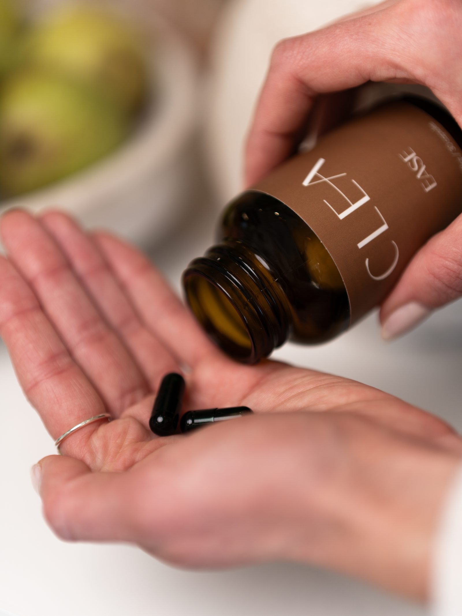 CLEA EASE gel capsules poured into an open palm